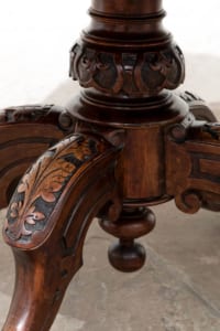 Antique Victorian walnut table with snap top and decorative carved legs