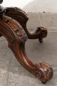 Antique Victorian walnut table with snap top and intricately carved legs