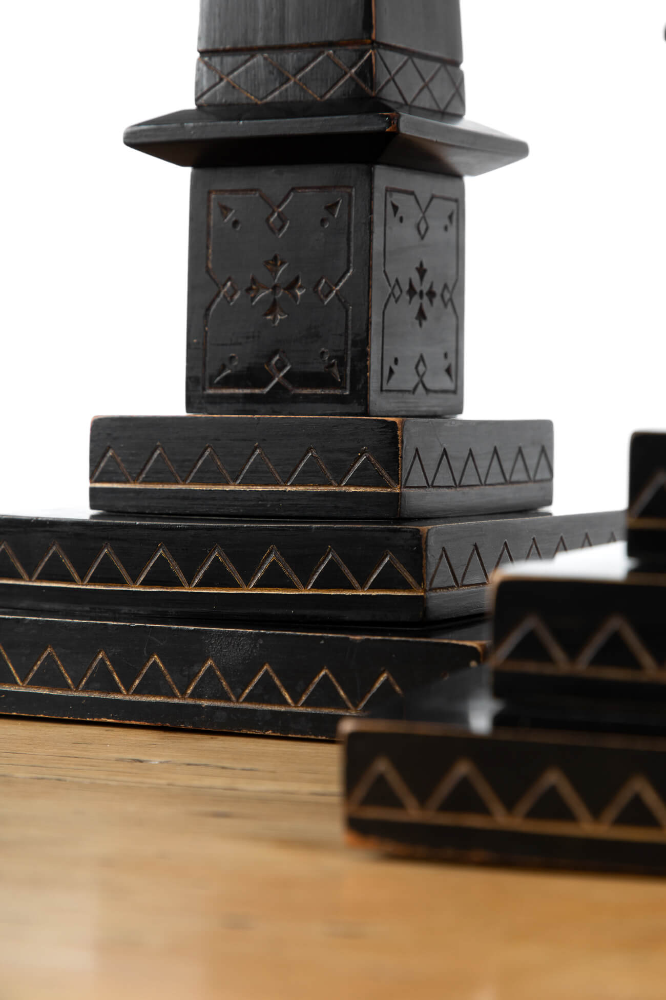 Pair of antique ebonised incise-carved library obelisks