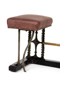 Antique club fender with leather upholstery and cast brass