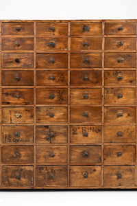 Antique bank of apothecary drawers
