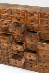 Antique bank of Victorian apothecary drawers
